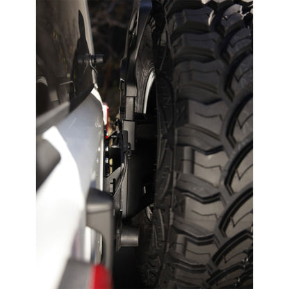 SMITTYBILT | JL Tire Relocation Bracket 2018-Up Jeep Wrangler JL Smittybilt |7721 mounted on a Jeep with a 37-inch tire.