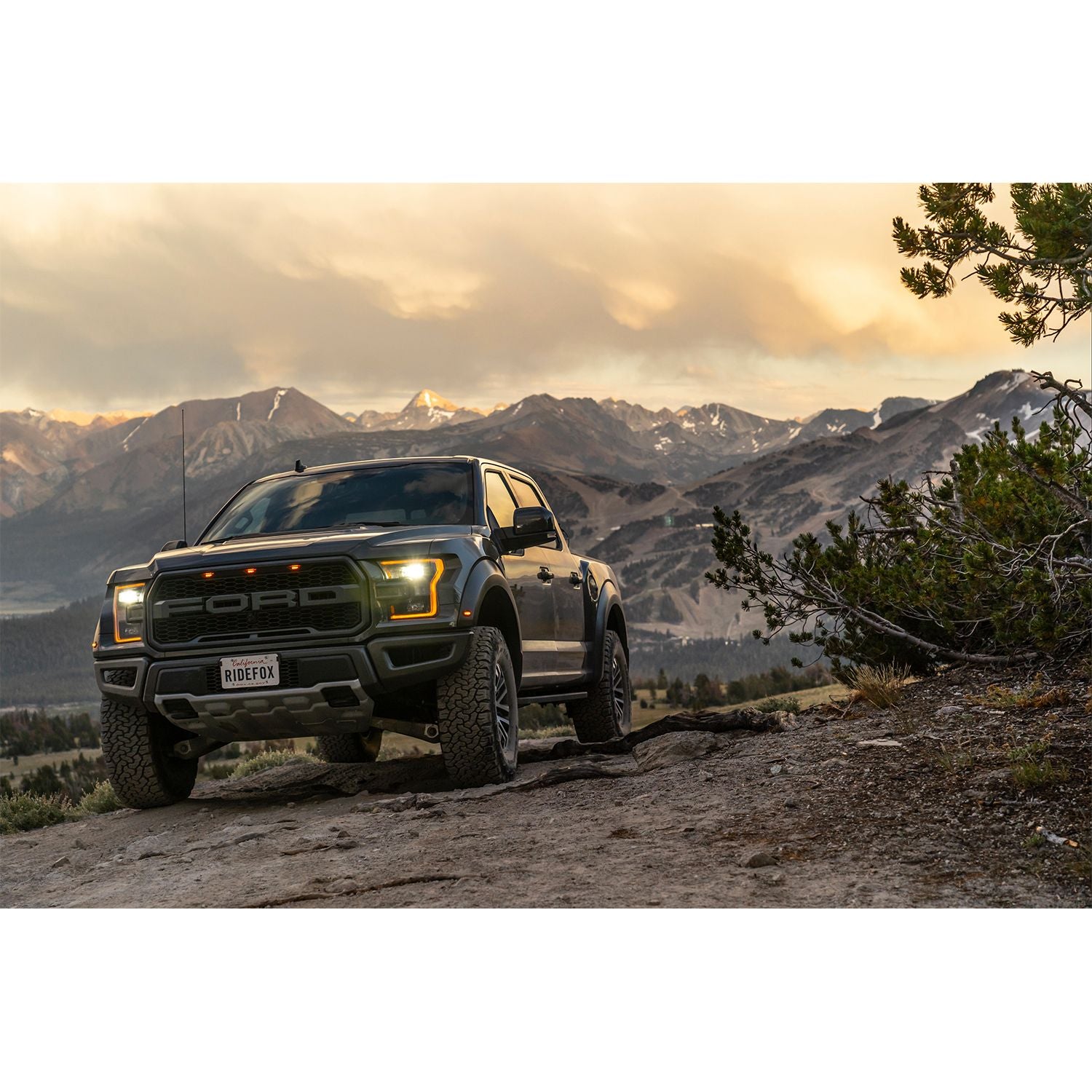FOX | Shock Absorber 19-On Ford Raptor Front Coilover Live Valve Internal Bypass 3.0 Series Remote Reservoir 7.9 Inch 0-2 Inch Lift Kit | 883-06-153 on rugged terrain.