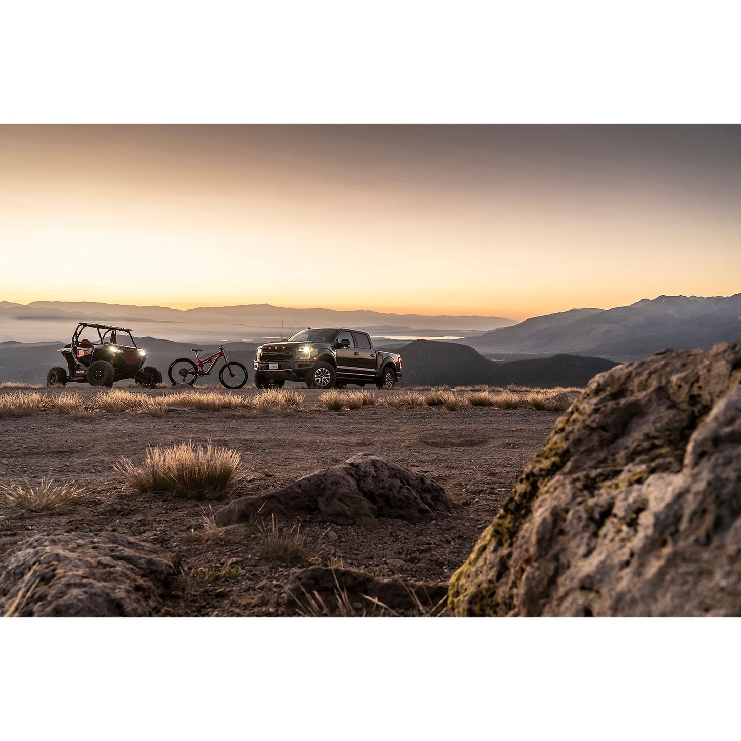 FOX | Shock Absorber 20-On Gm 2500/3500 HD Front Performance Series 2.0 IFP 4.9 Inch 0-1 Inch Lift | 985-24-238 truck and off-road vehicle in sunset mountain scenery.