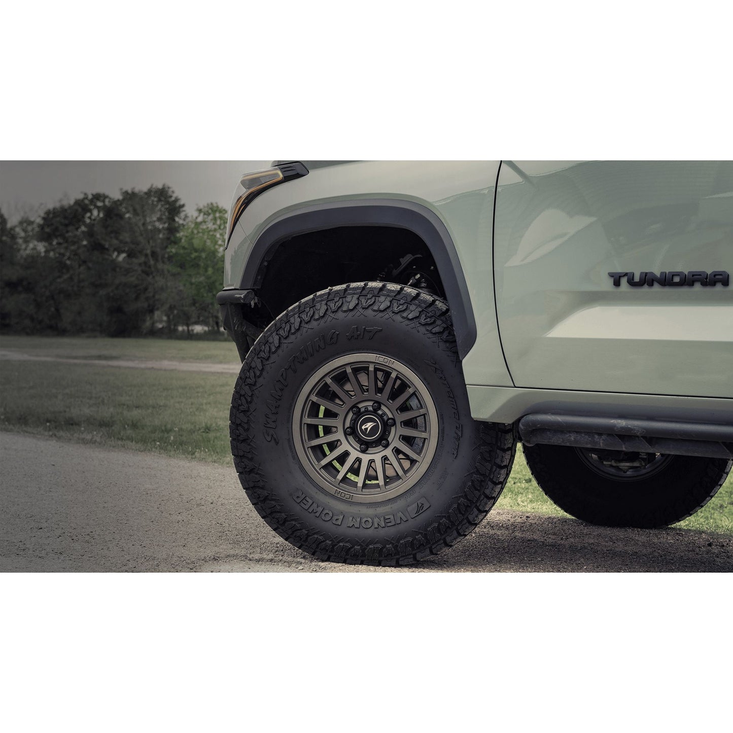VENOM Swampthing A/T tire mounted on a vehicle showcasing rugged all-terrain design and style.