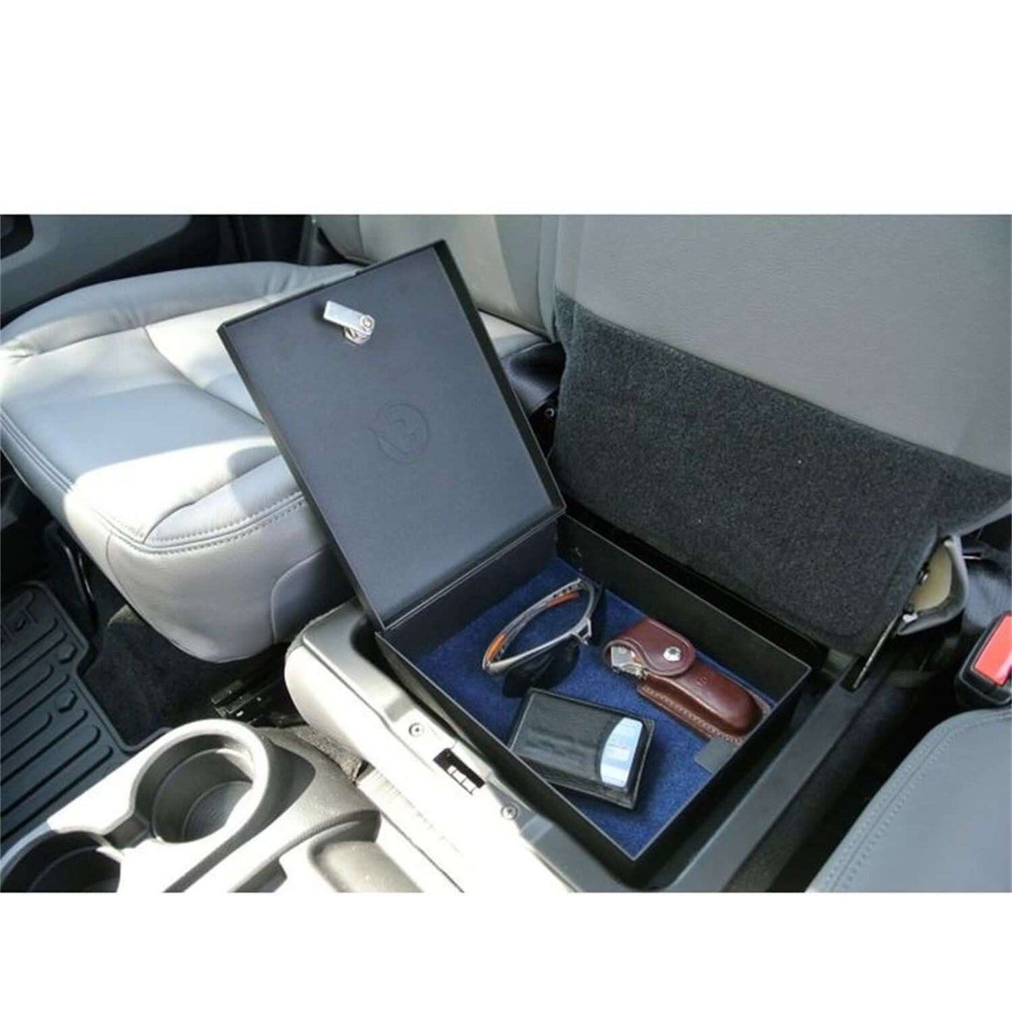 Underseat Lock Box Black Incl. Security Cable/Key Lock I 42644-01 with sunglasses and wallet inside a vehicle.