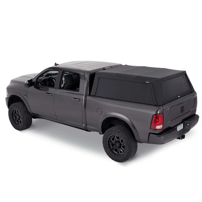 BESTOP | Supertop Truck Bed Cap 2 For Supertop for Truck 2 - '19-2024 Ram 1500 5.7 Foot Black Diamond PVC Coated Sailcloth No Drill Bestop | 77327-35 installed on a gray truck.