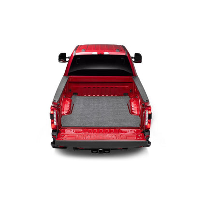 BedRug Bedmat For Spray-In Or No 17-24 Ford Super Duty 6.5' Bed 3/4 Inch Thick Bed Mat - Charcoal (BMQ17SBS) installed in a red truck bed.