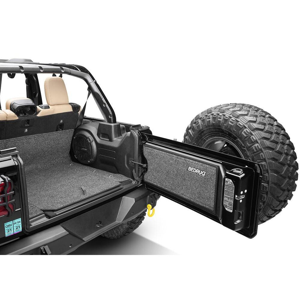 BedRug 2018-2026 Jeep Wrangler 4 Door Bed Liner - Charcoal (BRJL18R4) installed in a Jeep interior with rear tire.