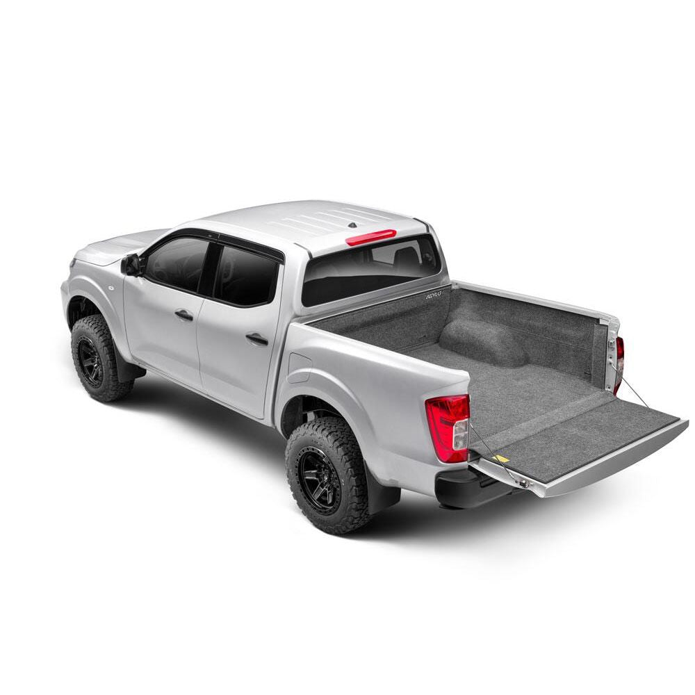 BedRug 04+ Nissan Titan Crew Cab 5.5' Bed Liner w/ Tailgate Mat - Charcoal (BRN04CCK) installed in a silver Nissan Titan.