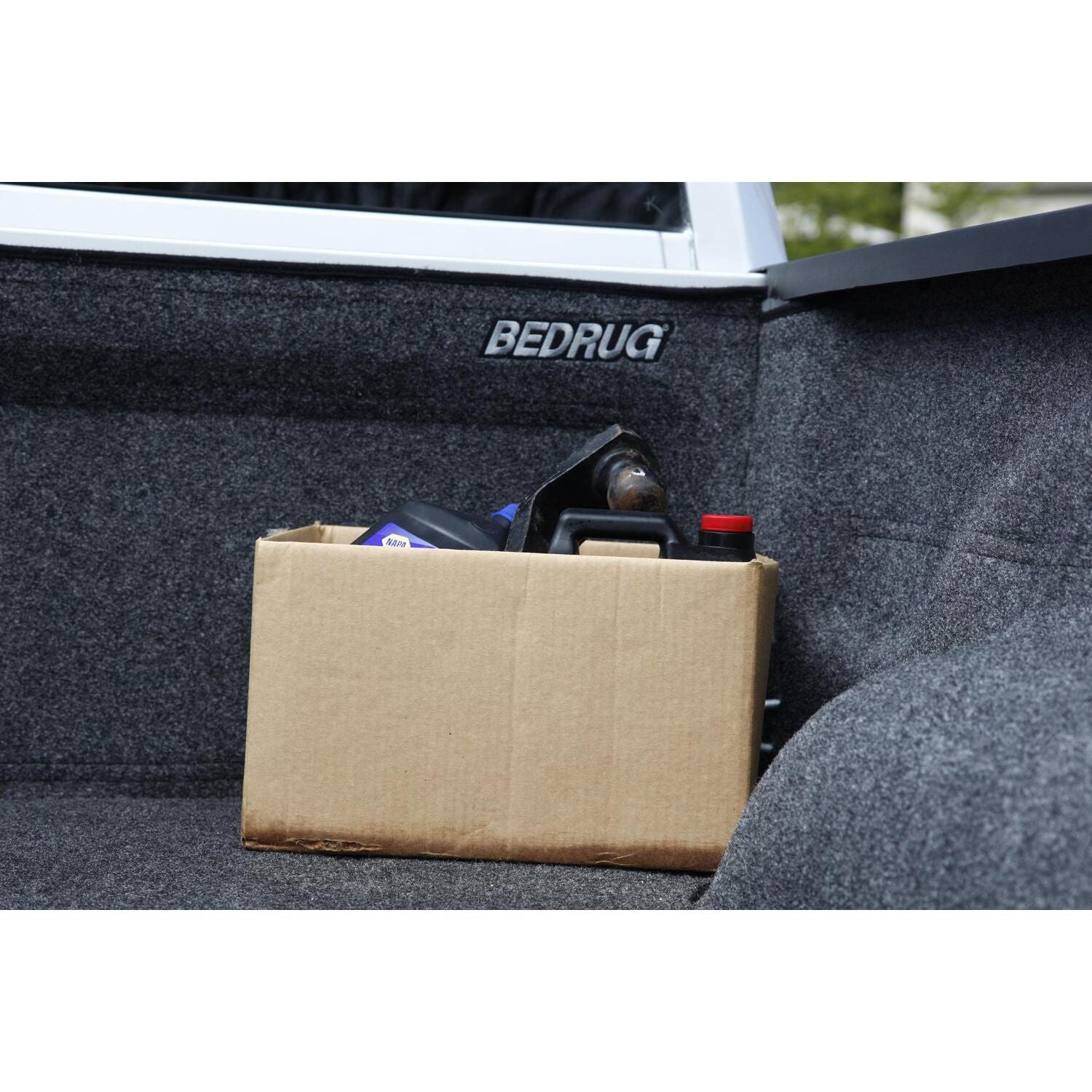 BedRug 02-18 - Charcoal (19-23 Classic) Ram 1500/03-24 2500/3500 8' showcasing a box in a truck bed.