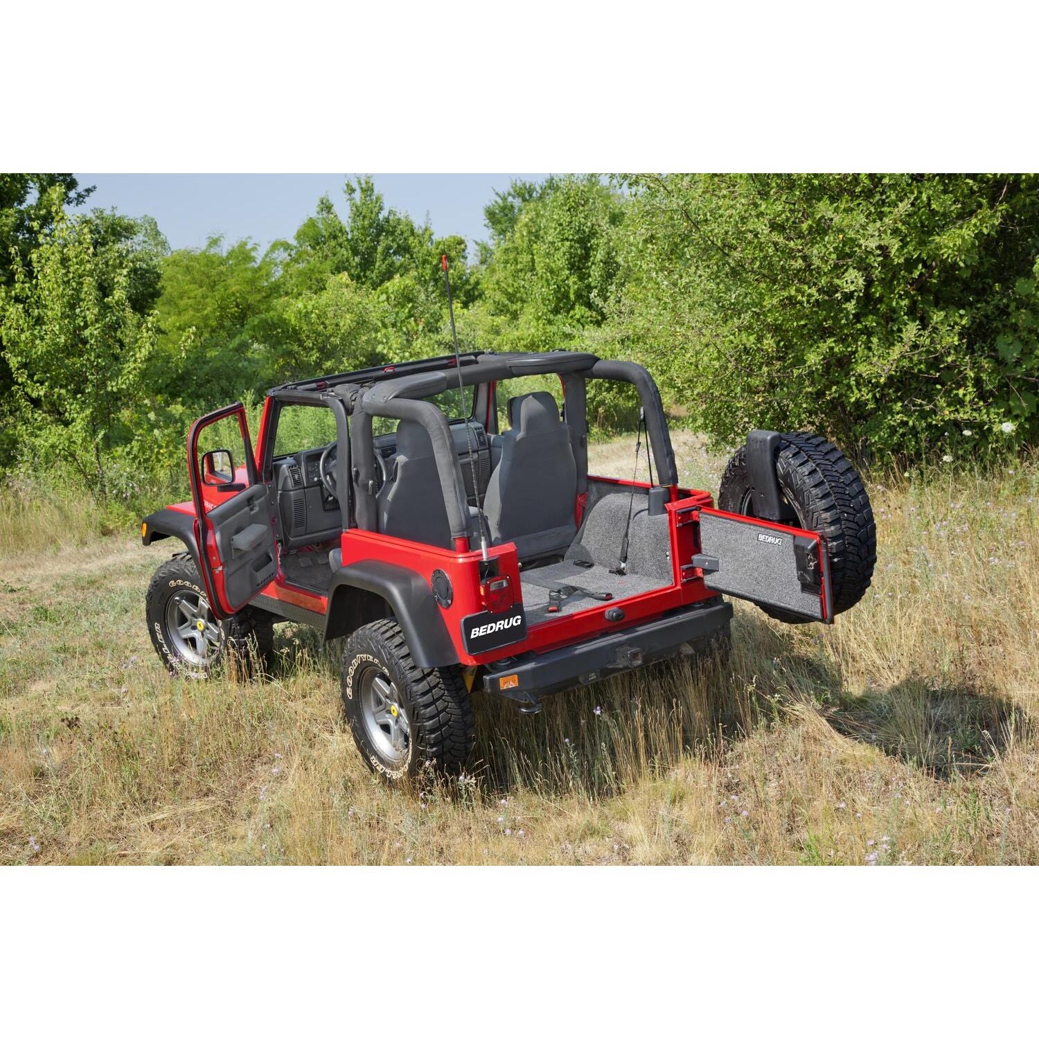 BedRug Jeep 97-06 Jeep TJ Rear Cargo Kit - Charcoal (Includes Tailgate) Cargo Kit installed in red Jeep with open tailgate.