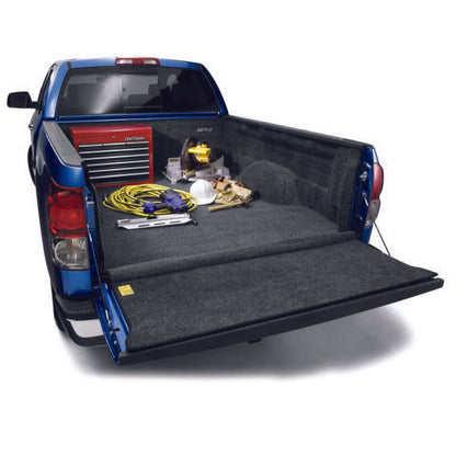 BedRug 07-21 Toyota Tundra 6.5' Bed Liner w/ Tailgate Mat - Charcoal (BRY07RBK) installed in truck bed with tools.