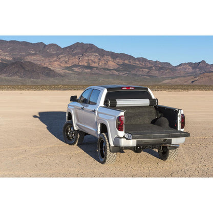 BedRug 07-21 Toyota Tundra 6.5' Bed Liner w/ Tailgate Mat - Charcoal (BRY07RBK) installed in truck bed on desert landscape.