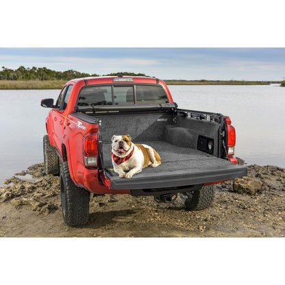 BedRug 07-21 Toyota Tundra 5.5' Bed Liner w/ Tailgate Mat - Charcoal (BRY07SBK) featuring a dog in the truck bed by a lake.