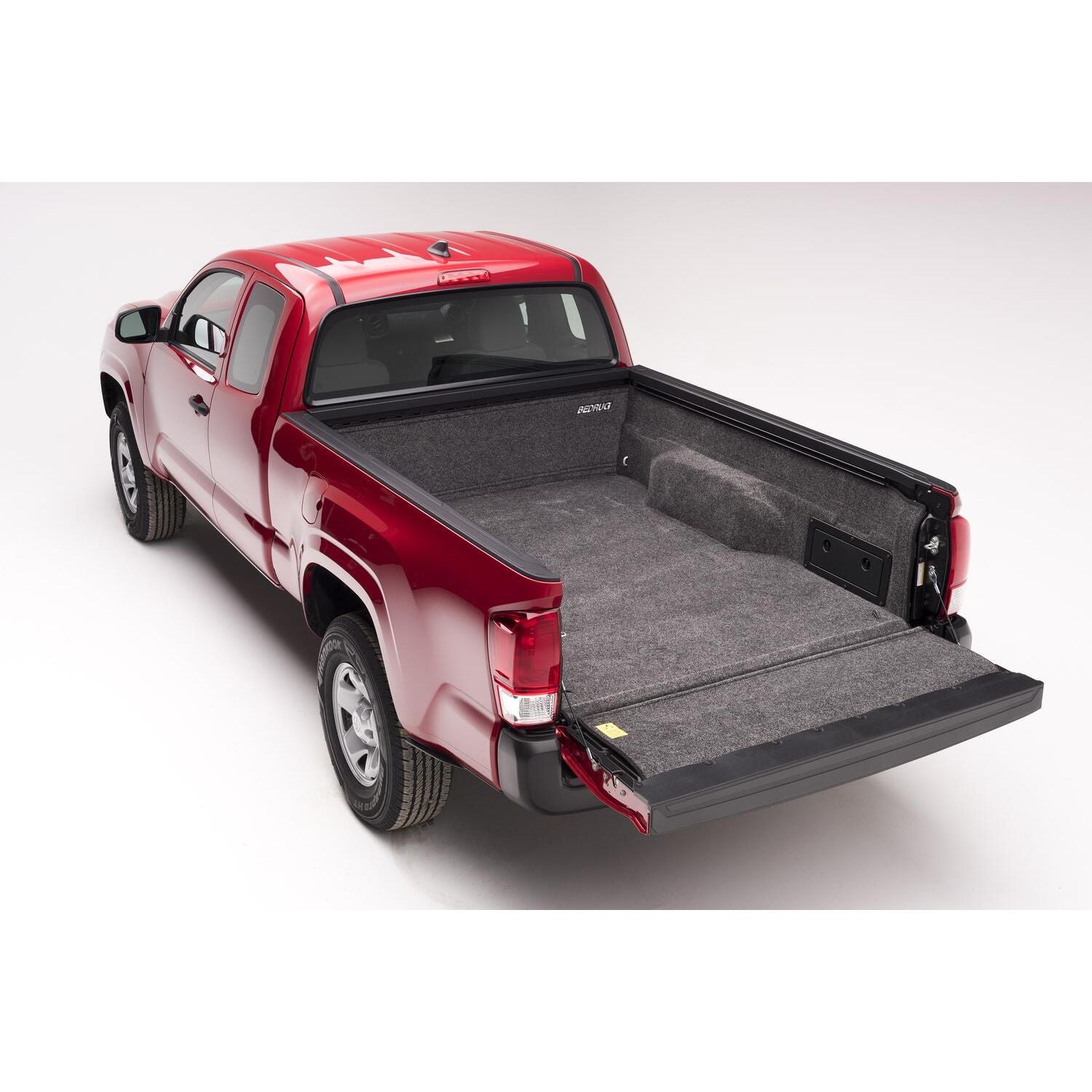 BedRug 05+ Toyota Tacoma 6'1" Bed Liner w/ Tailgate Mat - Charcoal (BRY19SBK) installed in red Toyota Tacoma truck bed.
