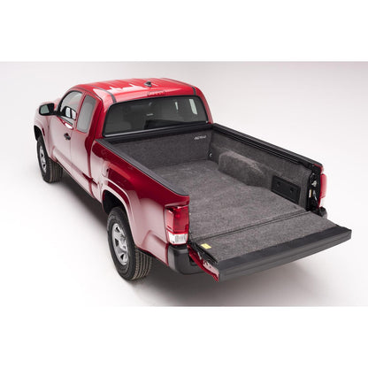 BedRug 05+ Toyota Tacoma 6'1" Bed Liner w/ Tailgate Mat - Charcoal (BRY19SBK) installed in red Toyota Tacoma truck bed.