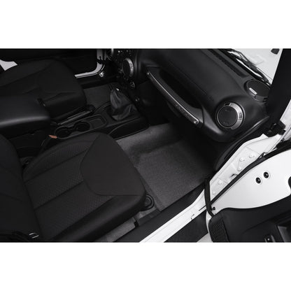 Interior view of a Jeep featuring the BedRug Jeep Bedtred 07-18 Jeep JK Unltd 4Dr Front 4Pc Floor Kit - Charcoal Bed Liner.